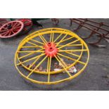 Ransomes, Ipswich, a pair of large red and yellow painted iron wheels, 135cm diameter