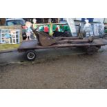 A vintage iron double axle trailer