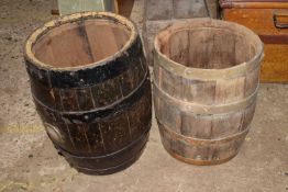 Two metal bound small wooden barrels