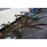 A large horse drawn iron framed single furrow plough, for restoration