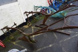 A large horse drawn iron framed single furrow plough, for restoration