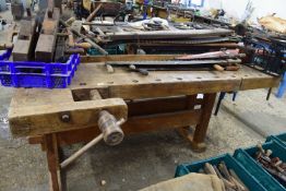 Large wooden workbench with wooden vice