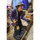 Glass fibre figure of a beggar