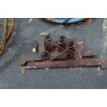 A set of three cast iron brackets with scroll work decoration, 95cm long