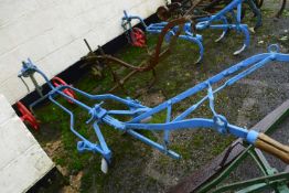 An iron framed horse drawn cultivator with blue and red painted body