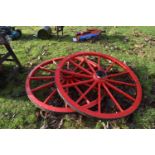 A pair of red painted cartwheels