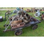 A twin axle iron and wood hand truck together with various machinery belts, hinges and other