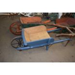 Wooden wheelbarrow with blue painted body and solid iron wheel