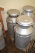 Pair of silver painted milk churns