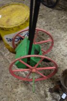 Small wood and iron framed seed drill painted red, green and black