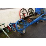 A horse drawn iron framed cultivator with discs, the body painted blue