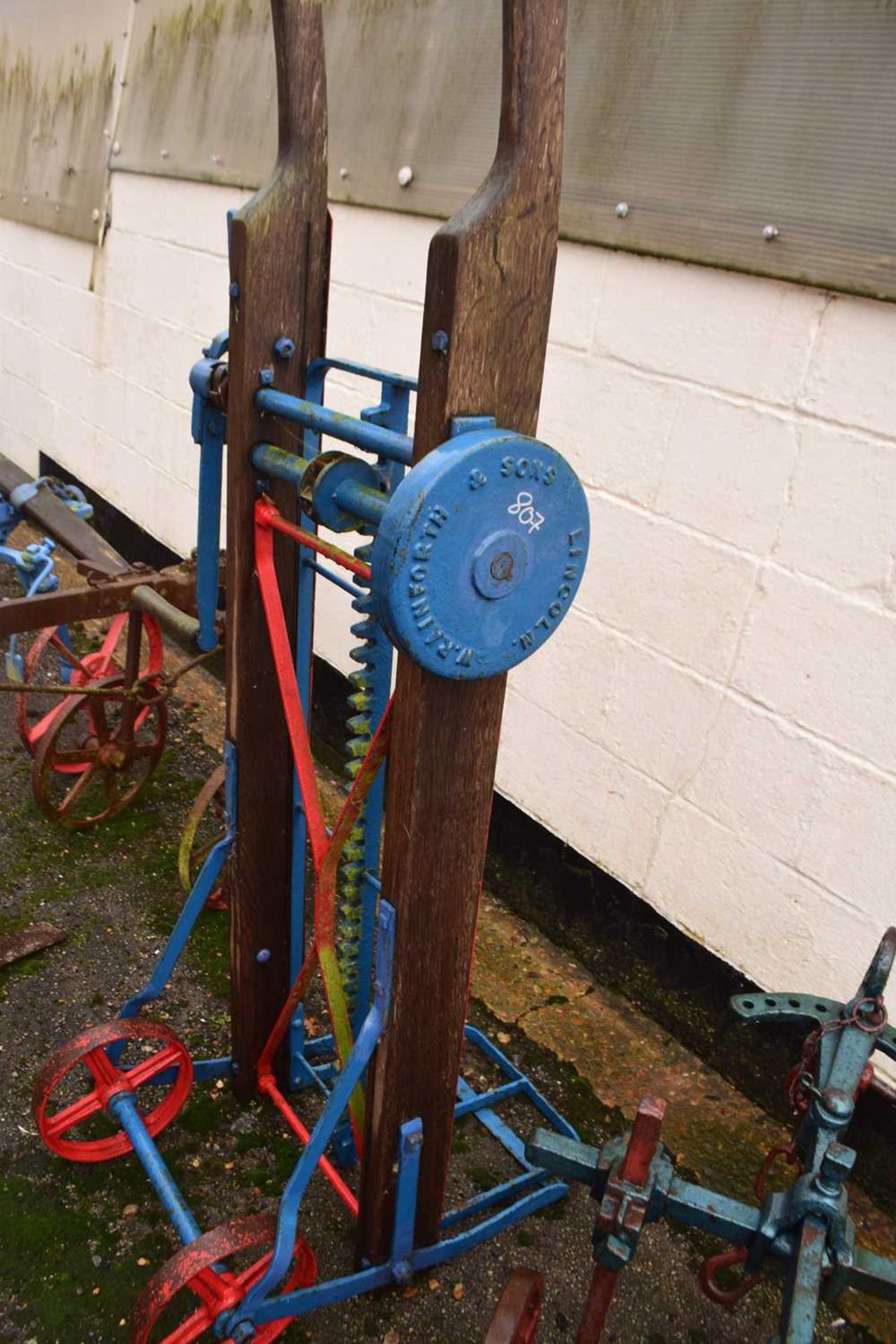 W Rainforth & Sons, Lincoln, a wood and iron framed sack lifting barrow with blue and red painted