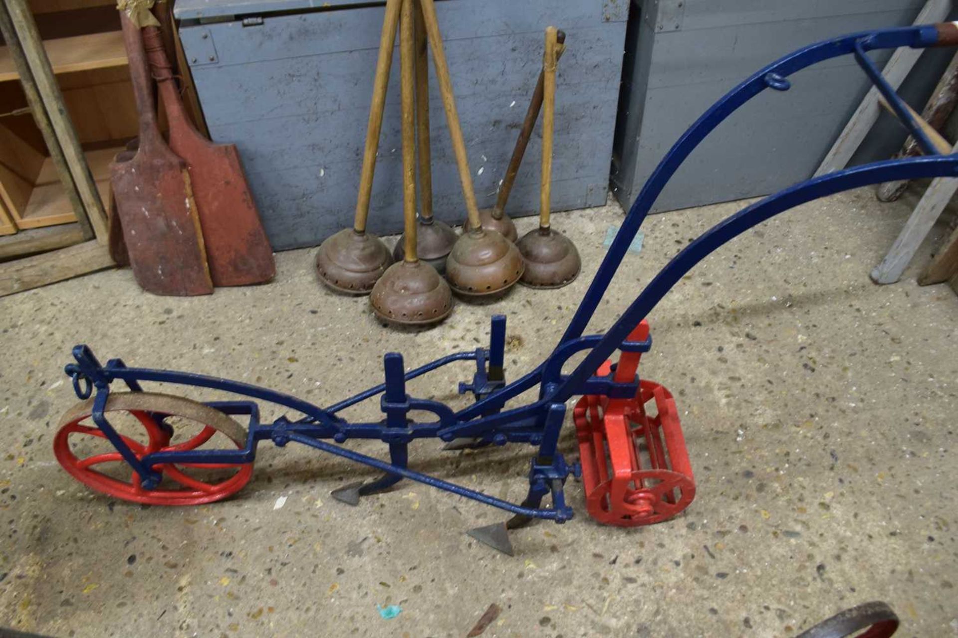 Iron framed cultivator with blue and red painted body