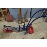 Iron framed cultivator with blue and red painted body