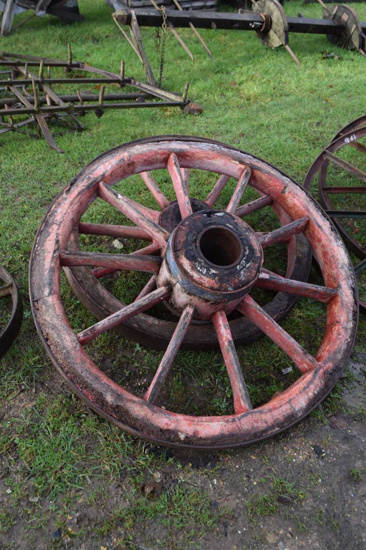 A pair of wood framed and iron mounted cart wheels