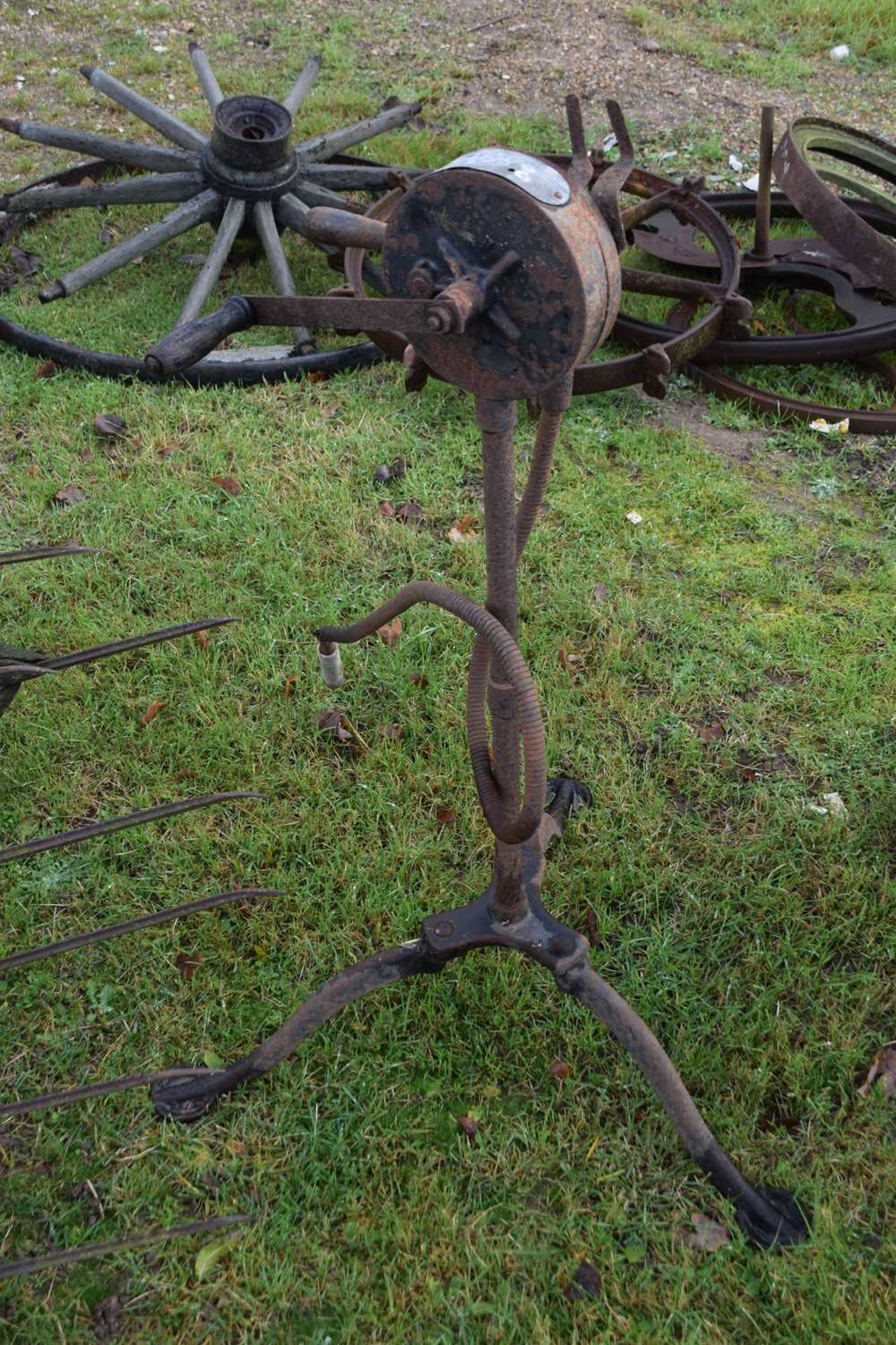 A vintage hand pump on iron tripod base