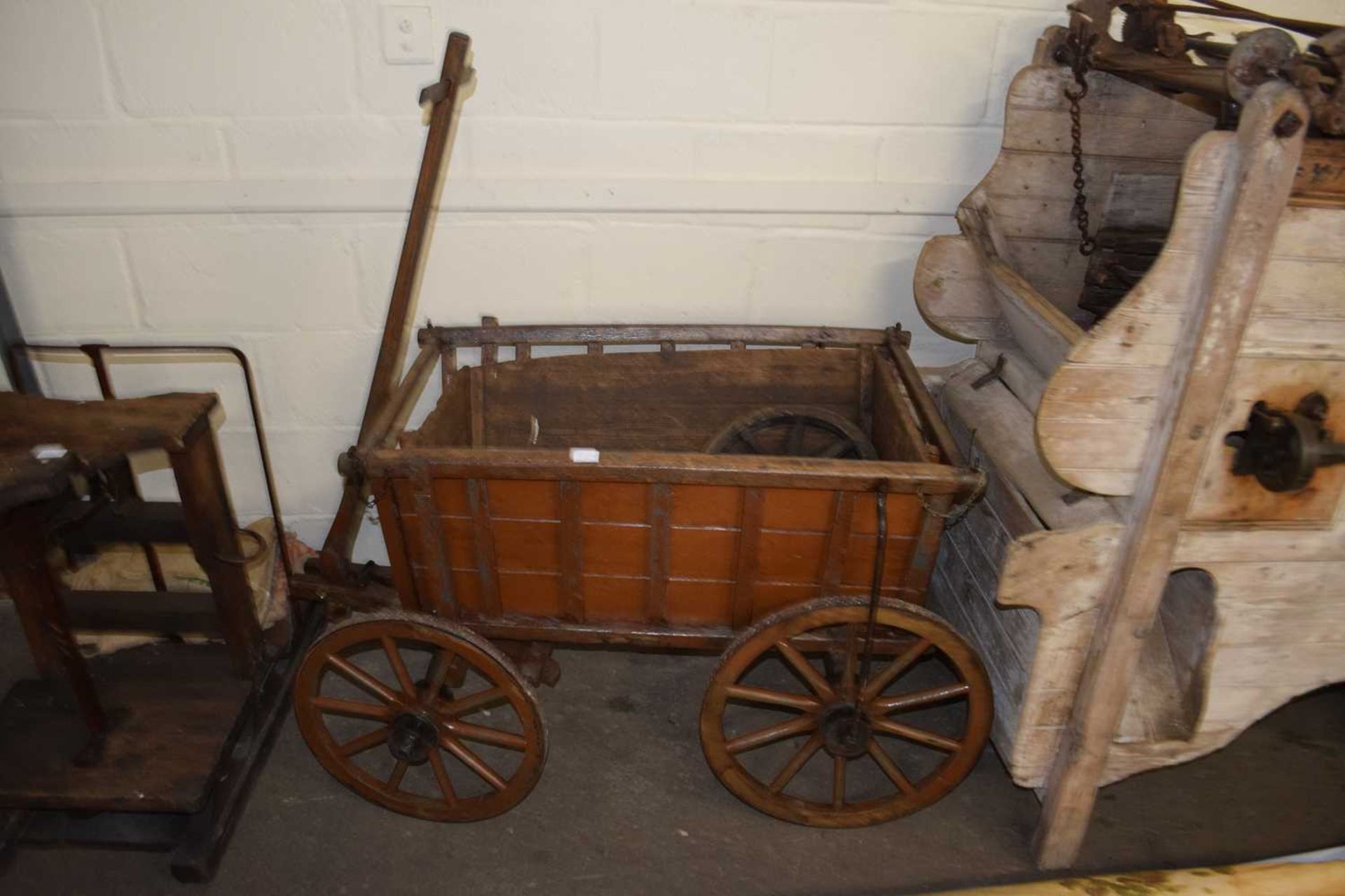 Vintage four wheeled hand cart with painted wooden body and iron mounted wheels