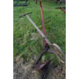 A single furrow hand plough together with a further small plough or cultivator marked AM.F & H Co,