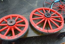 Two red painted wooden cartwheels