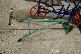 Small green painted iron plough