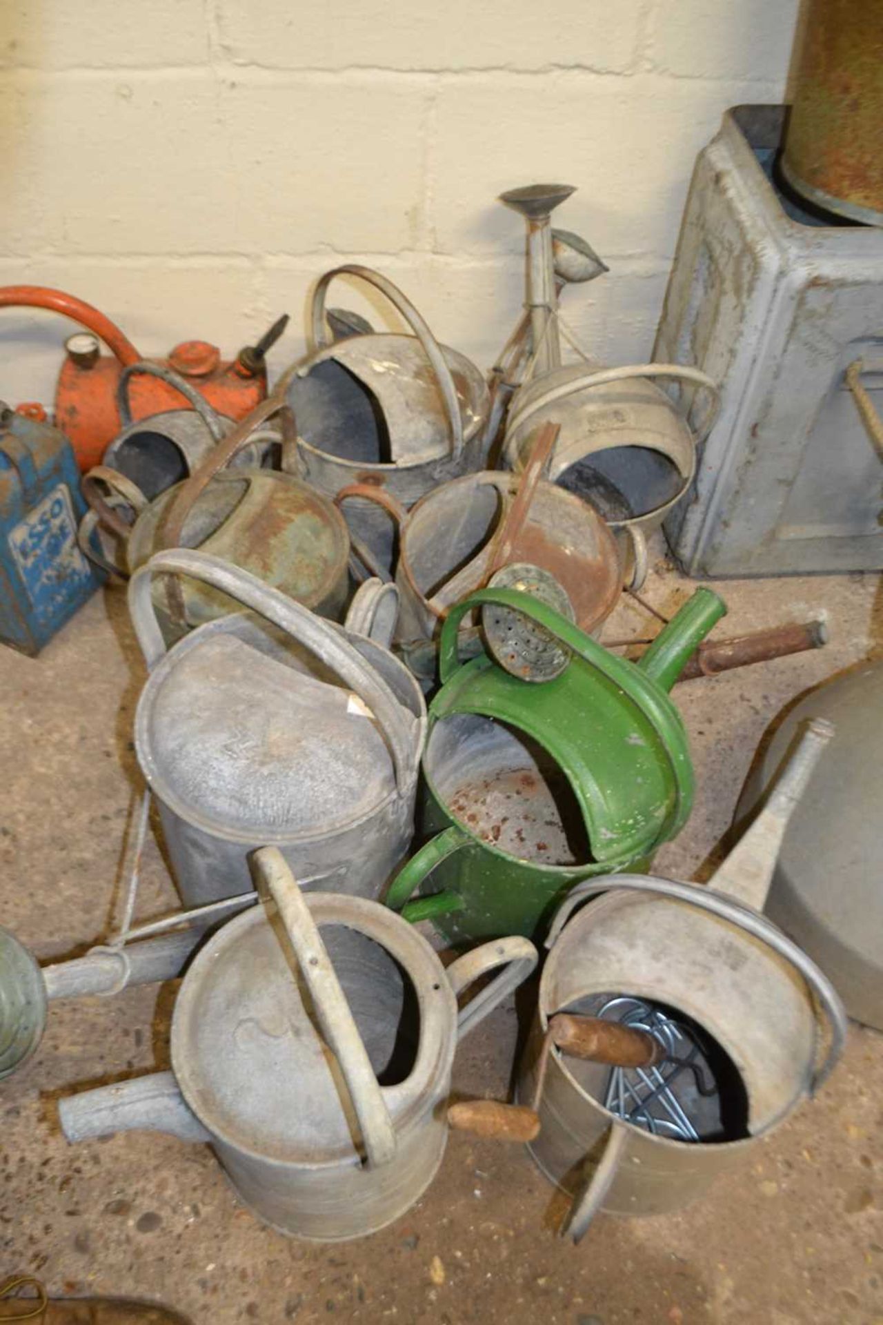 Group of nine various galvanised watering cans