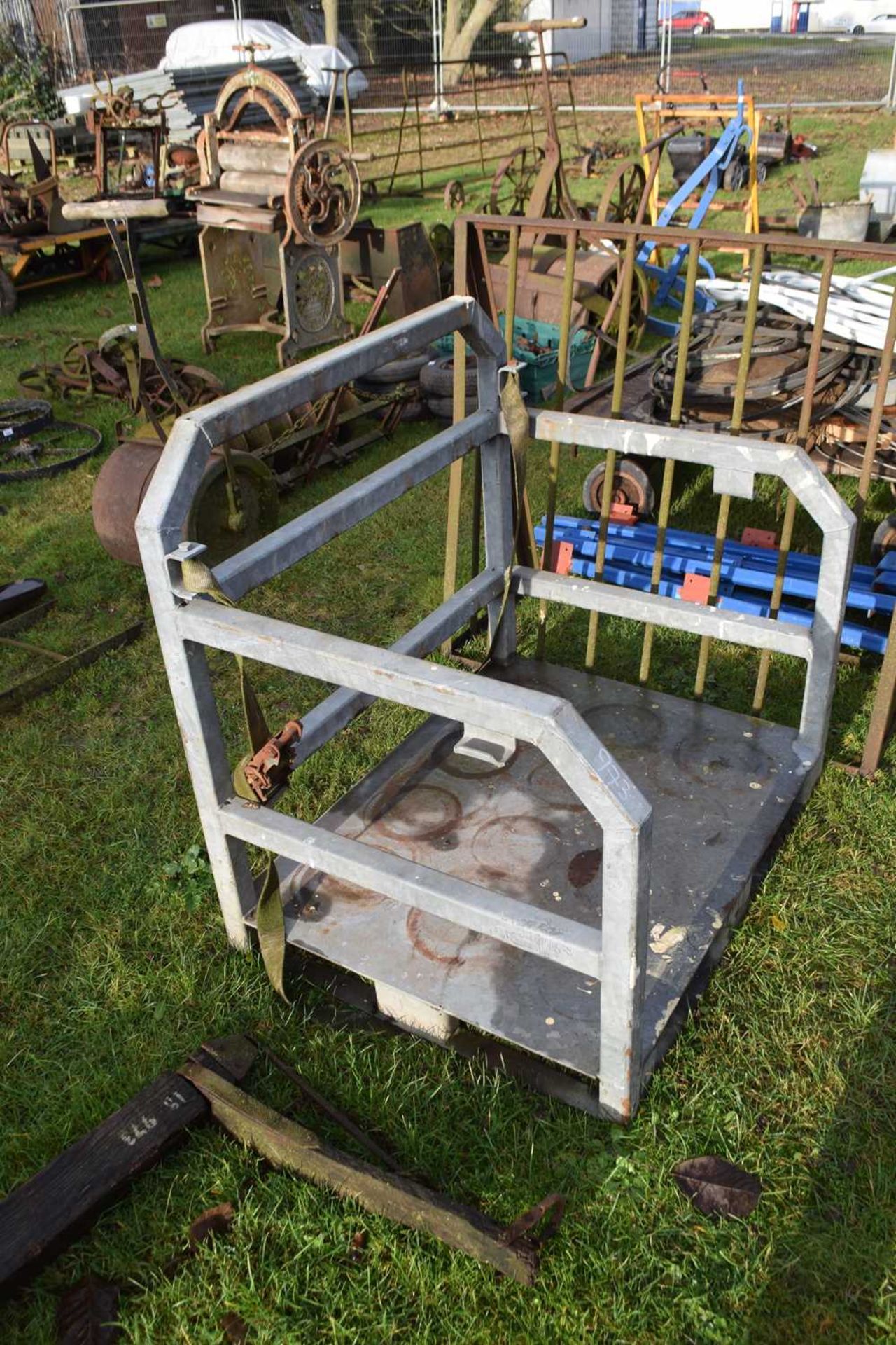 A galvanised transport cage with straps