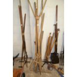 Bundle of various wooden handled hay forks, wooden rake and other tools, possibly for thatching