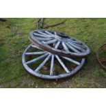 A pair of blue painted cart wheels