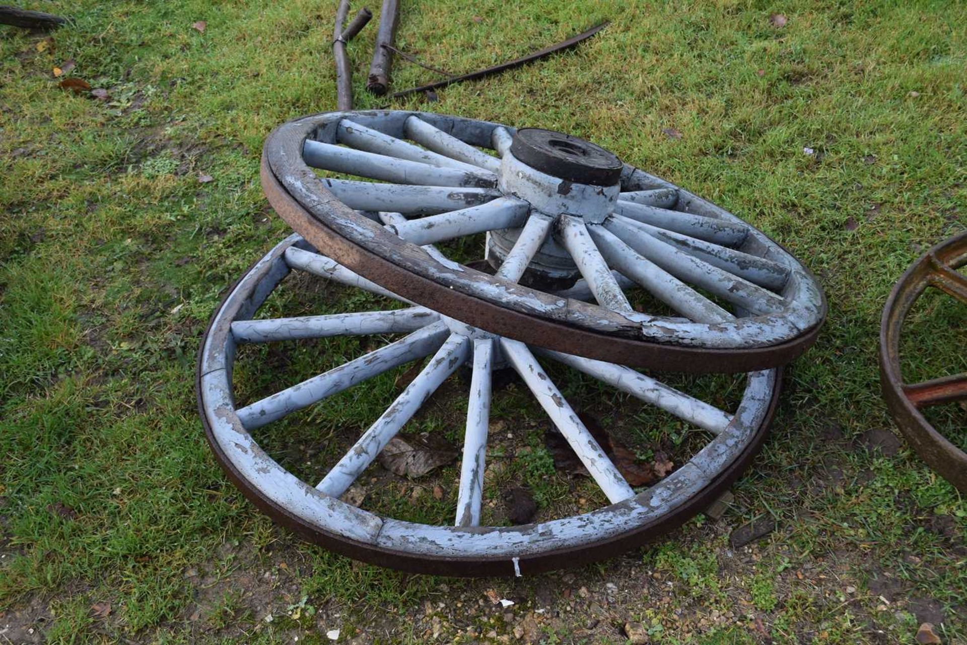 A pair of blue painted cart wheels