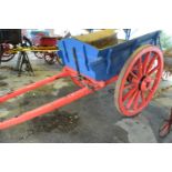 Large single axle wooden farm cart with iron mounted wheels, painted in red and blue