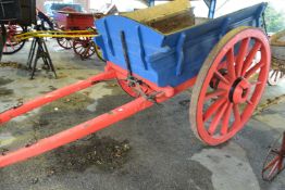 Large single axle wooden farm cart with iron mounted wheels, painted in red and blue