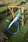 A blue painted iron tractor attachment