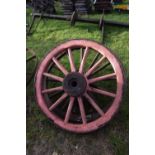 Two wood framed and iron mounted cart wheels