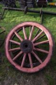 Two wood framed and iron mounted cart wheels