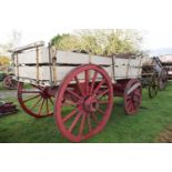 A twin axle farm wagon painted in red and cream for restoration together with a range of further
