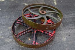Two iron wheels, largest 73cm diameter