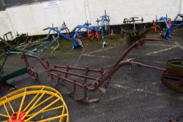 An iron framed horse drawn cultivator with adjusting wheel