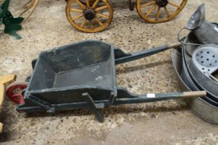 Green and red painted child's wheelbarrow