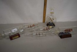 A collection of modern glass miniature ships in bottles