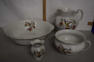 Floral decorated wash bowl, jug, chamber pot and toothbrush mug