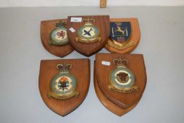 Collection of Royal Airforce and other military emblems mounted on hardwood shield backs