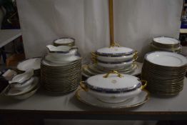 A Limoges gilt rimmed dinner service with vegetable dishes, graduated meat plates, sauce boats,