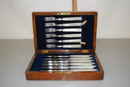 A case of mother of pearl handled dessert cutlery