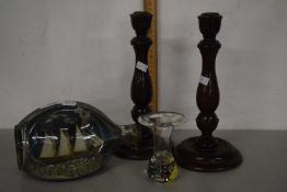 A glass ship in a bottle together with a further glass vase and a pair of wooden candlesticks (4)