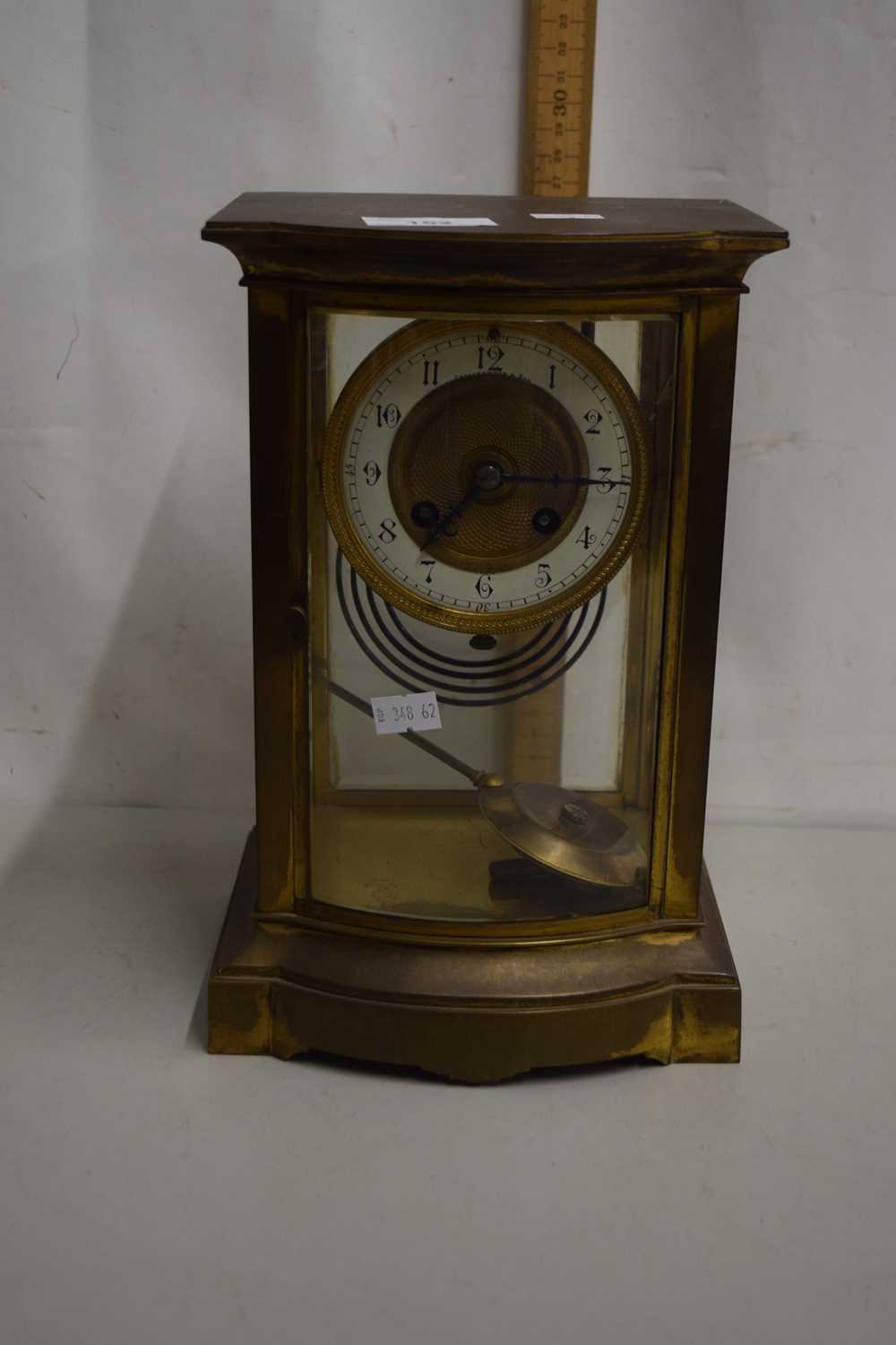 Collingwood & Sons, brass and glass cased mantel clock with brass movement striking on a coil -