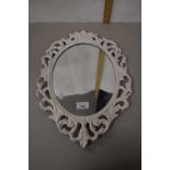 Oval wall mirror in cast metal frame
