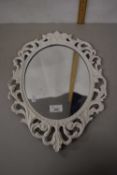 Oval wall mirror in cast metal frame