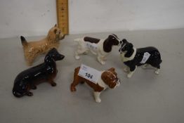 A collection of five various Beswick and other model dogs
