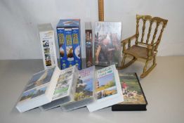 Box of various assorted videos, brass model rocking chair etc