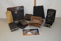 A box of mixed items to include a folding postcard camera, opera glasses etc